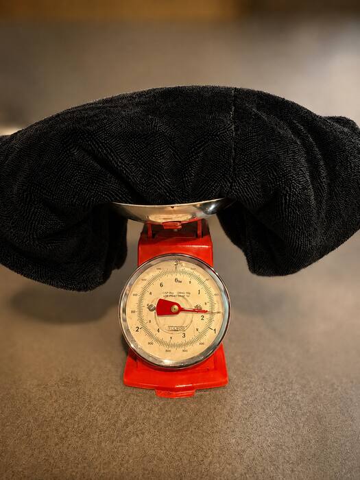 The Ducking Wet 1400 GSM towel on a Fox Run scale — needle pointing to 1.6 lb